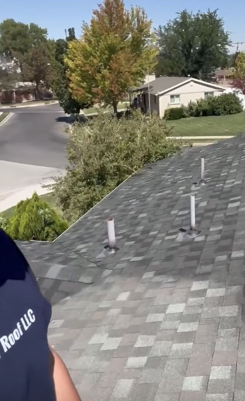 Revive Your Roof crew member working on an asphalt shingle roof on a Utah home