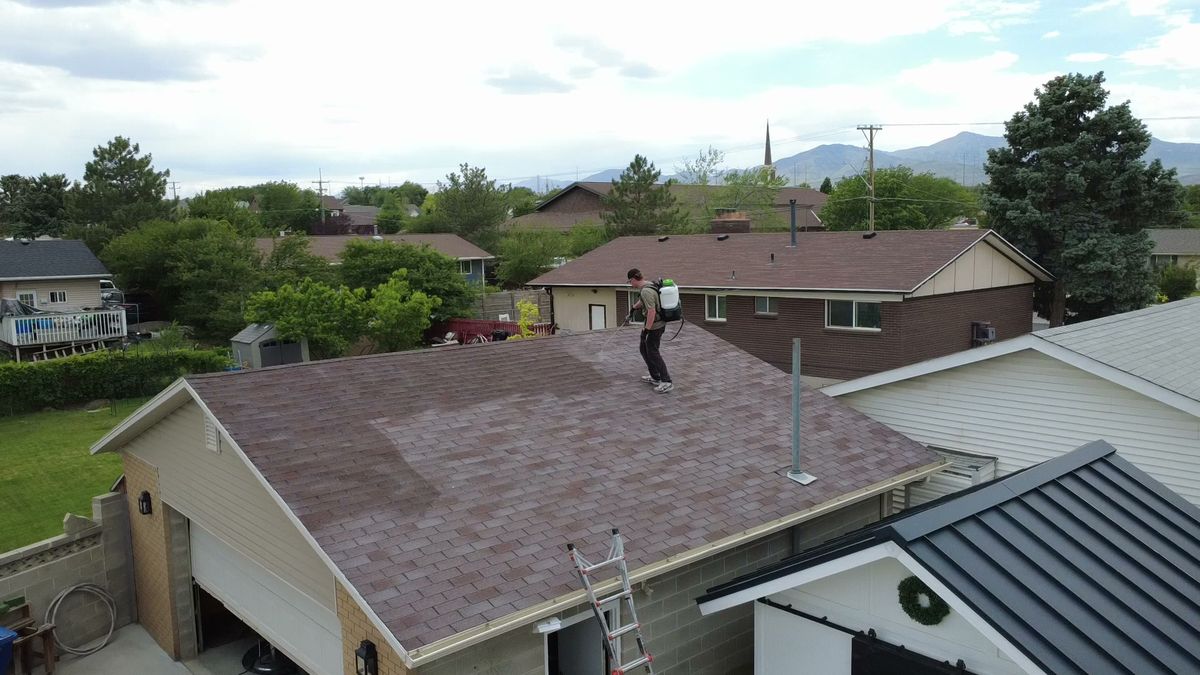 Aerial view of a mountain home roof being treated by Revive Your Roof