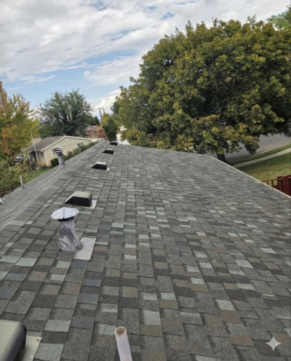 Grey asphalt shingle roof and ridge vent on a Utah home