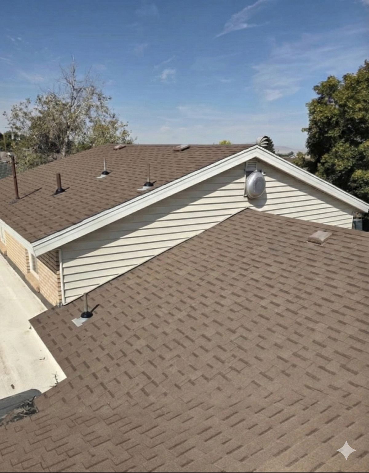 Restored brown asphalt shingles on a Utah roof after treatment