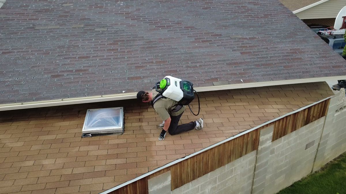 Revive Your Roof technician doing detail work around a skylight, on a Wasatch Front home in Utah