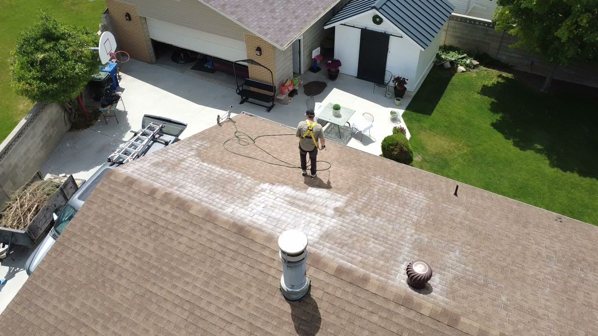 Overhead view of a Utah roof partway through a rejuvenation treatment