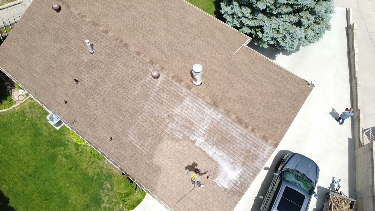 A Utah roof part way through a rejuvenation treatment, treated section beside untreated